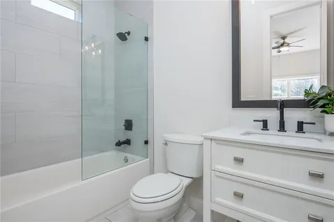 a living room with furniture and a ceiling fan