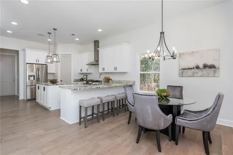 a view of kitchen with island and stainless steel appliances