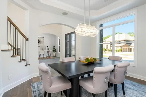 a view of a dining room with furniture and chandelier