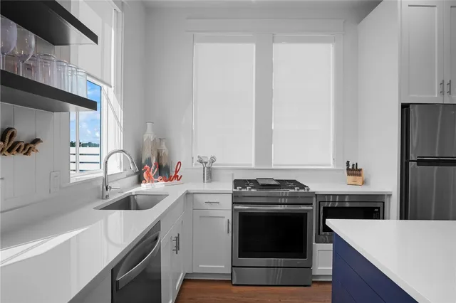 a kitchen with a sink stove and refrigerator