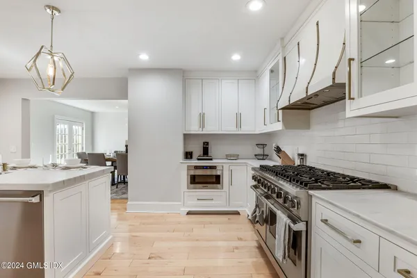a kitchen with a sink stove and cabinets