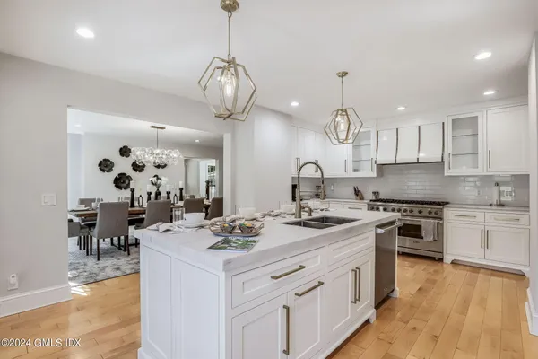 a kitchen with sink refrigerator and stove