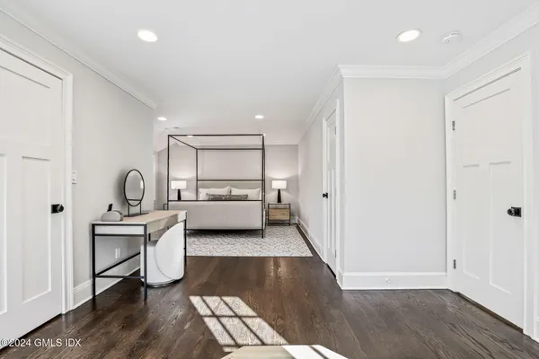a bedroom with a bed and wooden floor