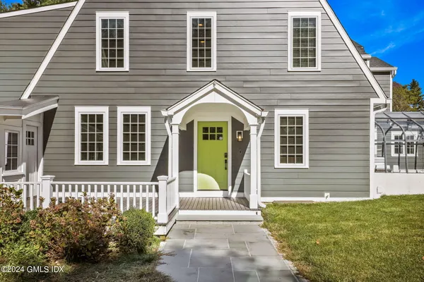 a living room with furniture a rug and white walls