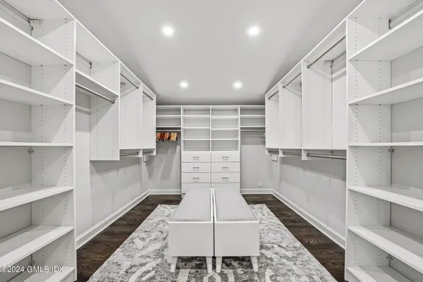 a bedroom with a bed and a television