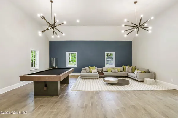 a living room with furniture a clock and a fireplace