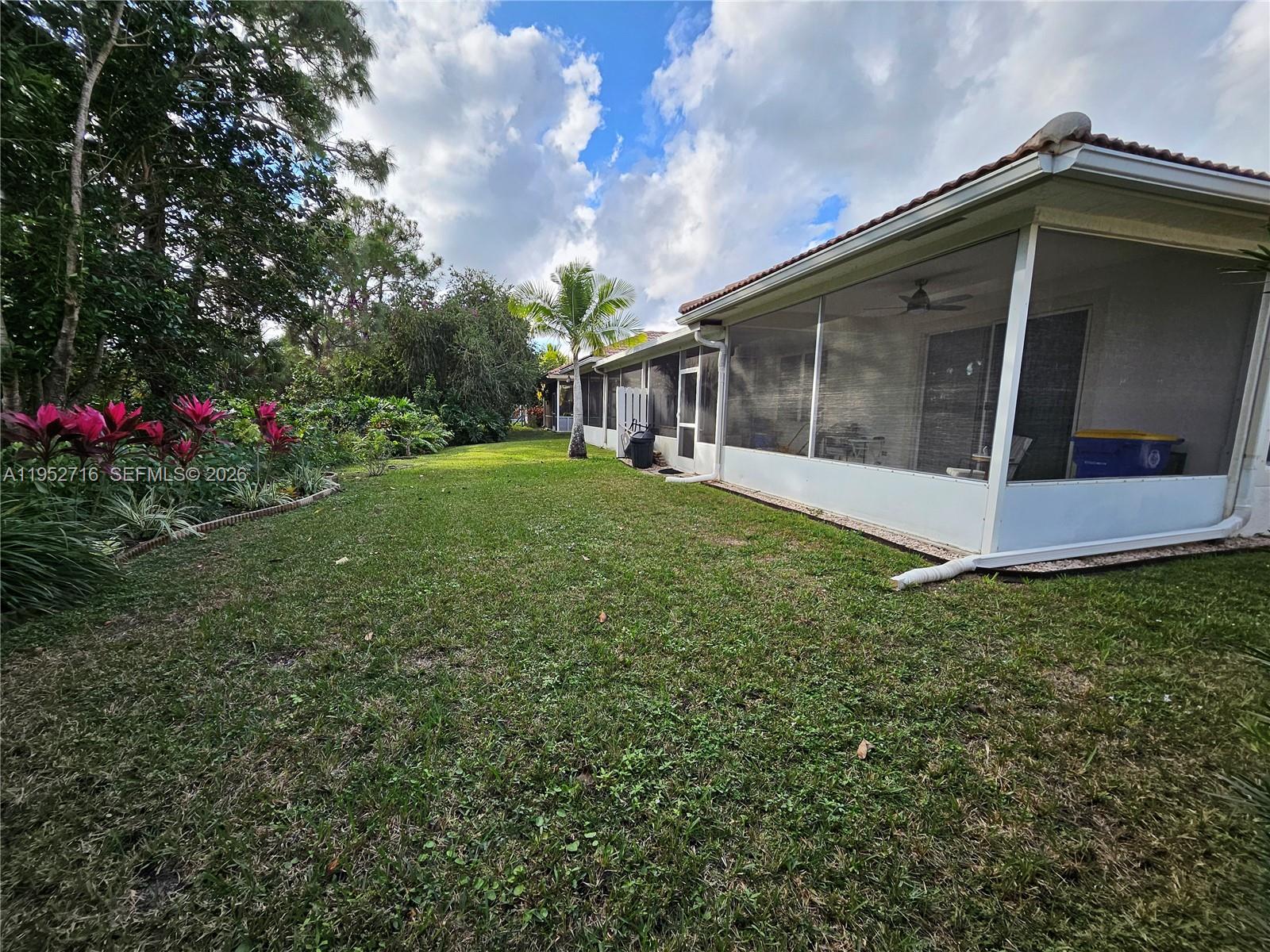 6785 Southeast Warwick Lane Stuart, FL 34997 - Photo 16 of 53 Large covered screened patio with garden view