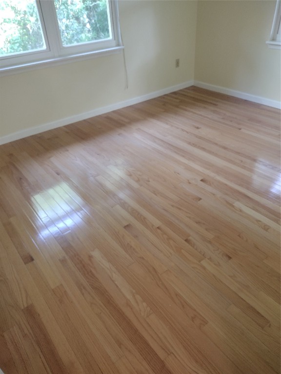 2403 B 1st Avenue Fernandina Beach, FL 32034 - Photo 11 of 17 an empty room with wooden floor and windows