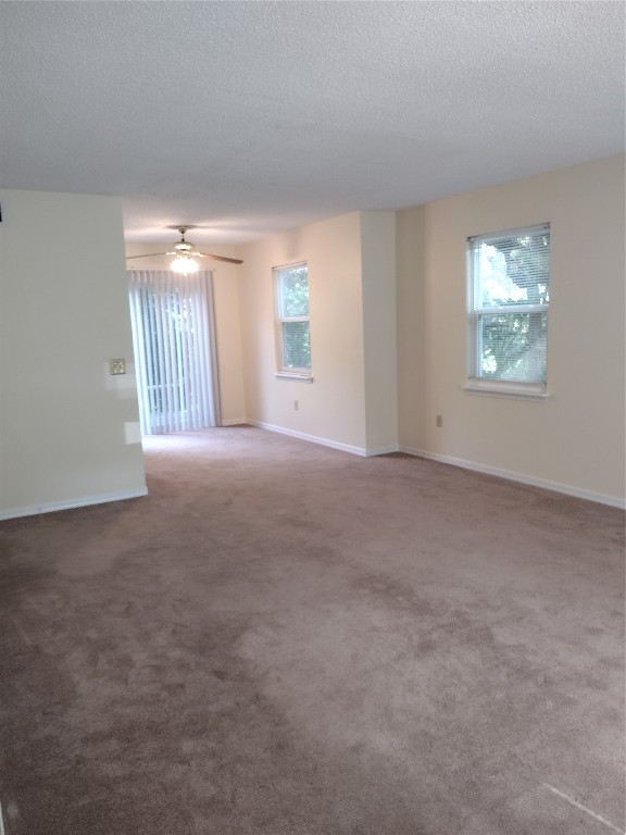 2403 B 1st Avenue Fernandina Beach, FL 32034 - Photo 7 of 17 a view of a big room with windows and chandelier fan