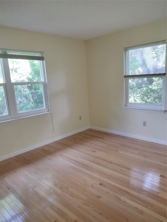 2403 B 1st Avenue Fernandina Beach, FL 32034 - Photo 10 of 17 an empty room with wooden floor and windows
