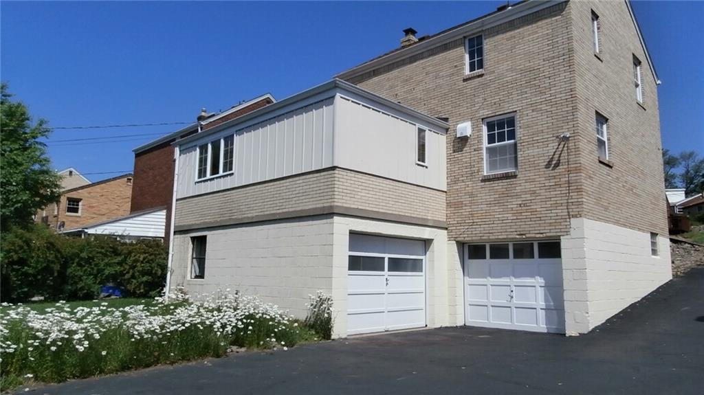 1030 Hastie Road Pittsburgh, PA 15234 - Photo 2 of 19 Exterior view of back of house - two separate integral garages with auto door openers - brand new garage door opener on the original garage - freshly painted exterior - upper level yard behind the flowers and a lower yard below