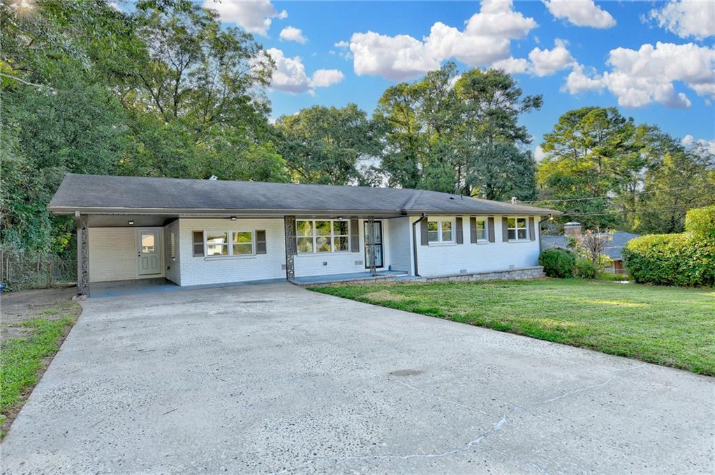 a view of a house with a yard and garden