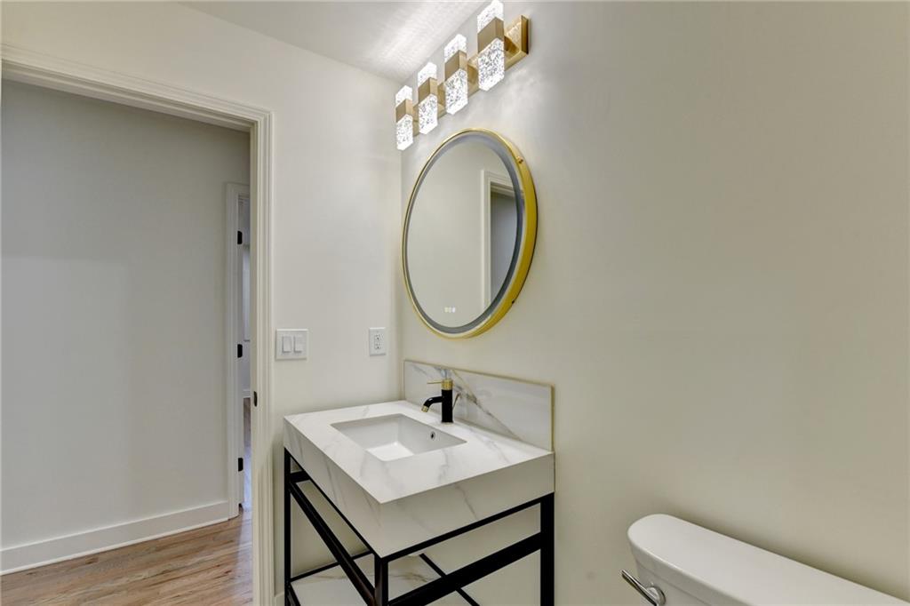 2181 Juanita Street Decatur, GA 30032 - Photo 12 of 15 a bathroom with a toilet sink and mirror