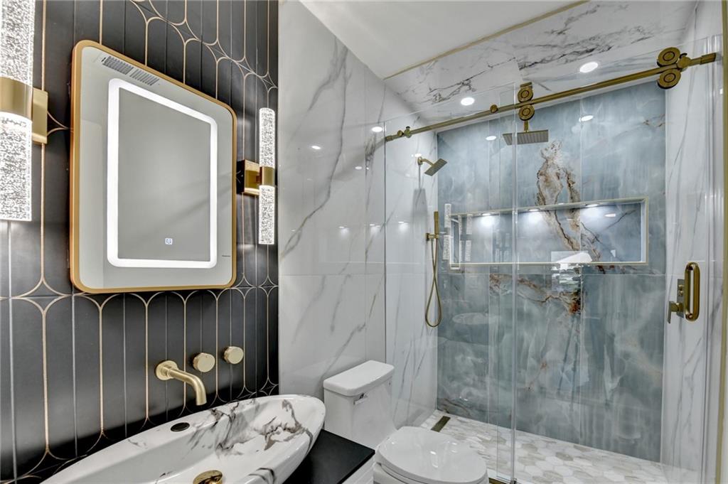 2181 Juanita Street Decatur, GA 30032 - Photo 13 of 15 a bathroom with a toilet a sink and shower