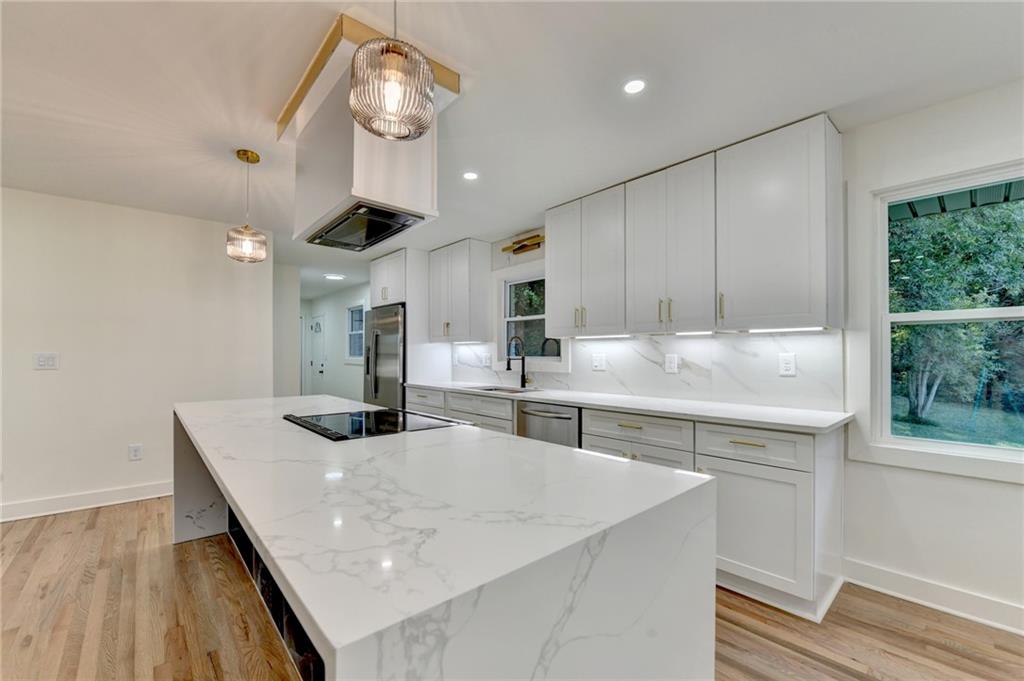 2181 Juanita Street Decatur, GA 30032 - Photo 8 of 15 a kitchen with stainless steel appliances granite countertop a sink window and cabinets