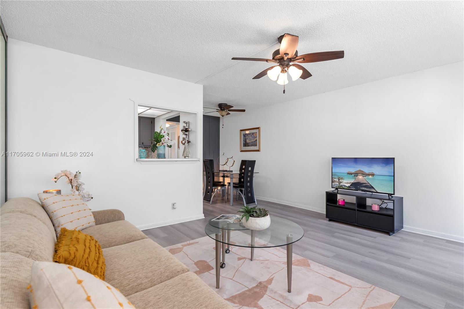 382 Markham R, Unit 382 Deerfield Beach, FL 33442 - Photo 2 of 30 a living room with furniture and a flat screen tv
