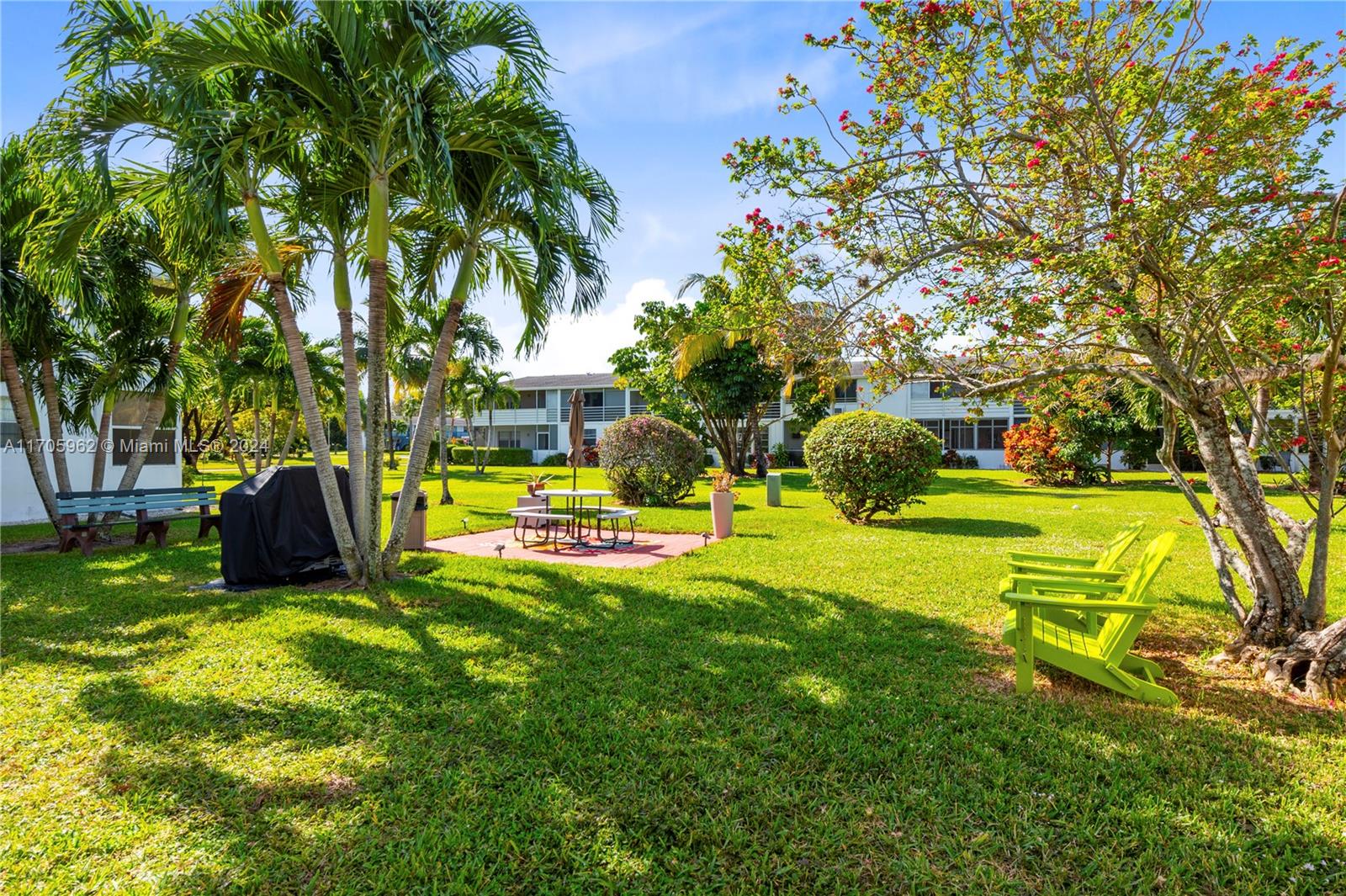 382 Markham R, Unit 382 Deerfield Beach, FL 33442 - Photo 22 of 30 a view of a swimming pool with a table and chairs