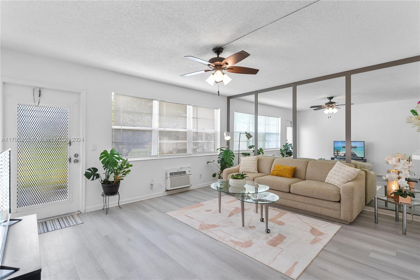 382 Markham R, Unit 382 Deerfield Beach, FL 33442 - Photo 3 of 30 a living room with furniture potted plant and a window