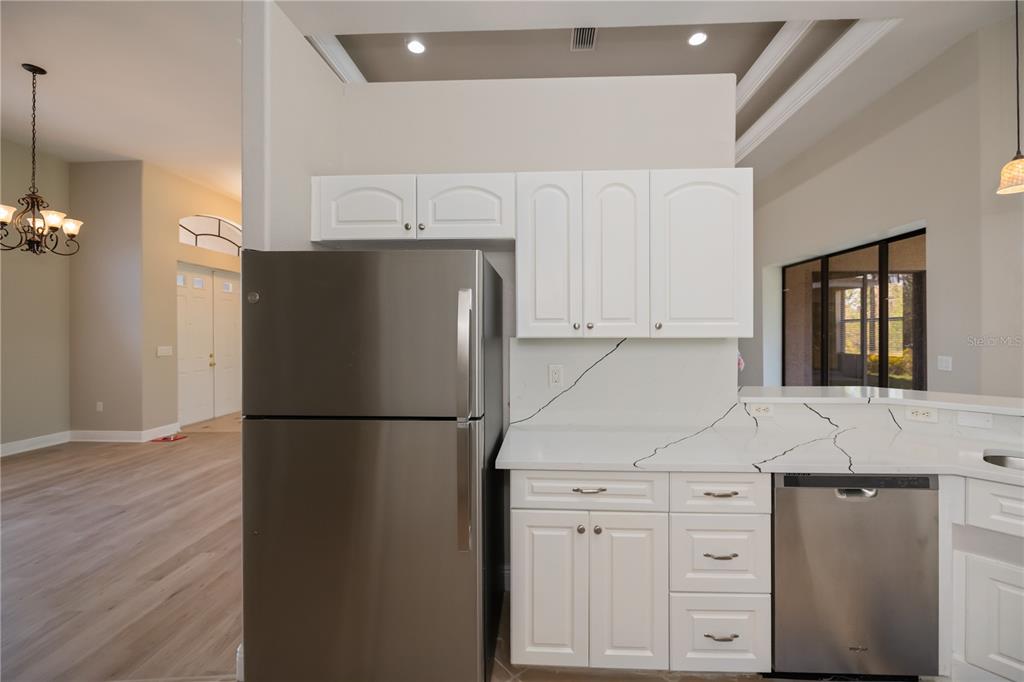 3284 Newmark Street North Port, FL 34291 - Photo 13 of 44 a white refrigerator freezer sitting in a kitchen