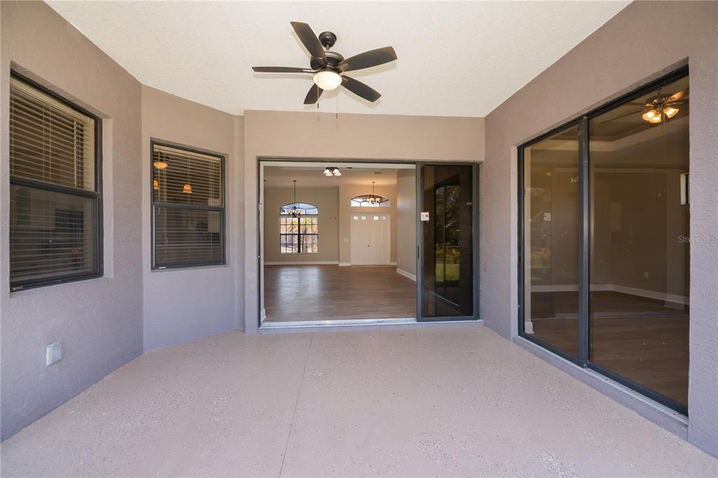 3284 Newmark Street North Port, FL 34291 - Photo 39 of 44 a view of a hallway with wooden floor and a ceiling fan