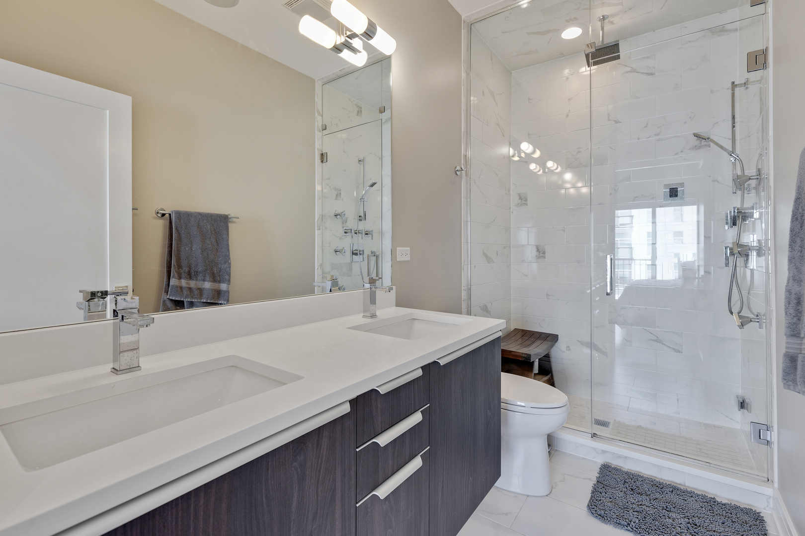 1820 West Haddon Avenue, Unit 2 Chicago, IL 60622 - Photo 15 of 18 a bathroom with a sink a toilet a large mirror and shower