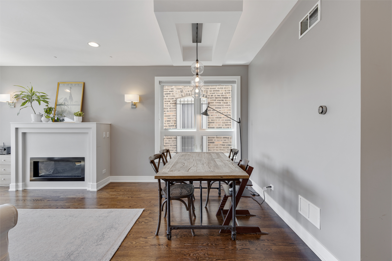 1820 West Haddon Avenue, Unit 2 Chicago, IL 60622 - Photo 4 of 18 a dining room with furniture a fireplace and wooden floor
