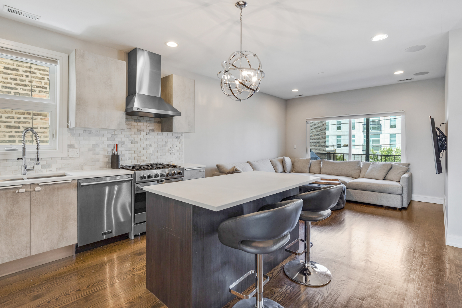 1820 West Haddon Avenue, Unit 2 Chicago, IL 60622 - Photo 6 of 18 a kitchen with a table chairs stove and wooden floor