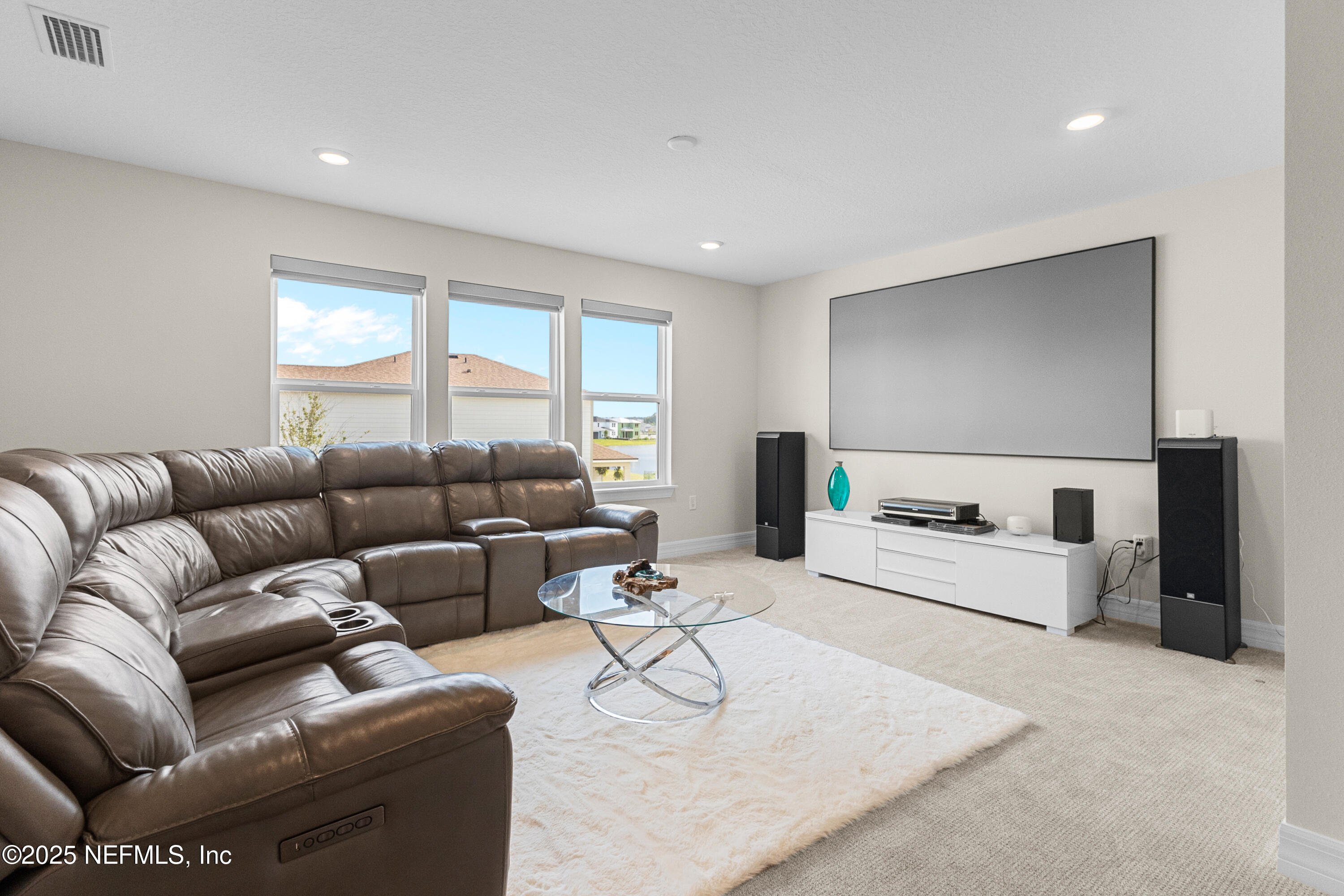 27 Flintlock Ln Street St. Augustine, FL 32095 - Photo 17 of 65 a living room with furniture and a flat screen tv