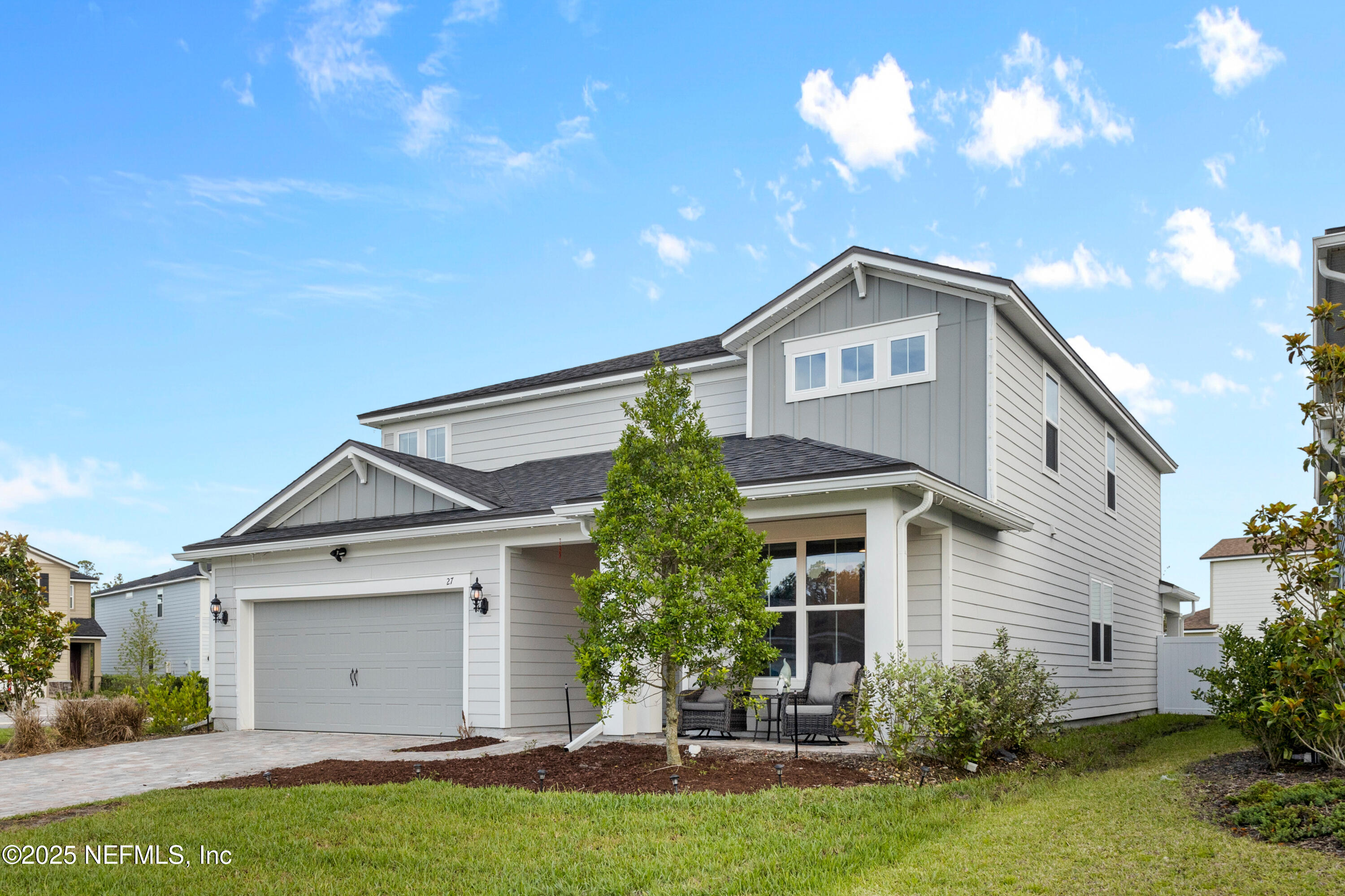27 Flintlock Ln Street St. Augustine, FL 32095 - Photo 20 of 65 a front view of a house with a yard and garage