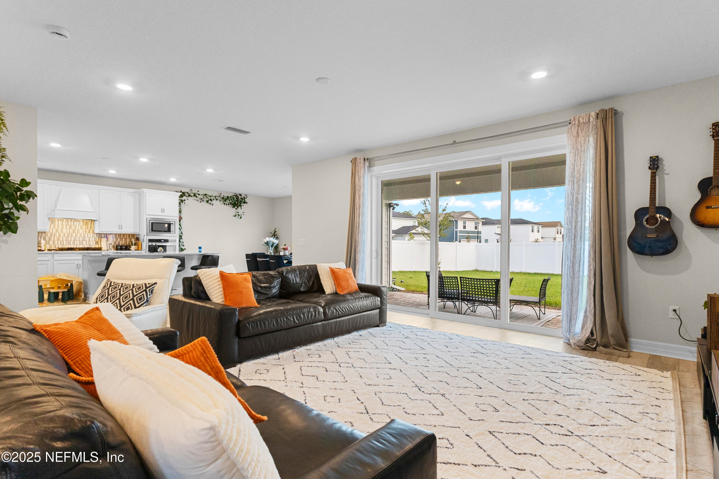27 Flintlock Ln Street St. Augustine, FL 32095 - Photo 22 of 65 a living room with furniture a flat screen tv and floor to ceiling window