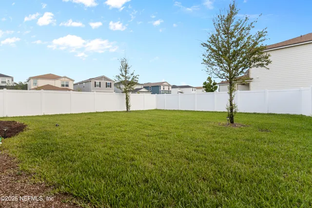 an aerial view of a residential houses with outdoor space