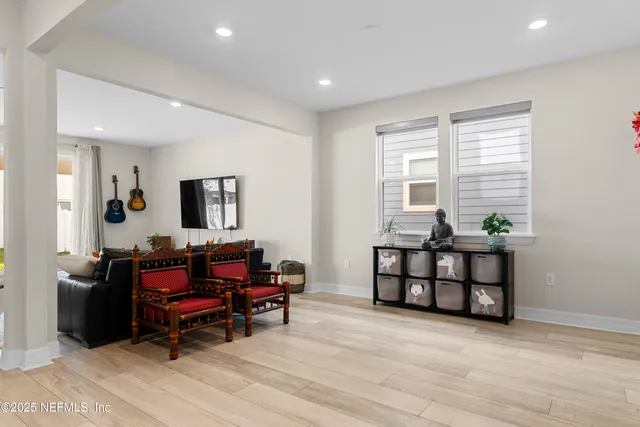 a living room with a couch a rug and a flat screen tv