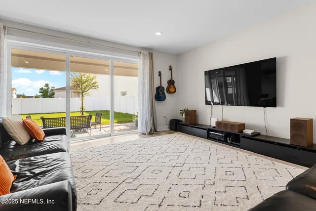 a view of a dining room with a table and chairs
