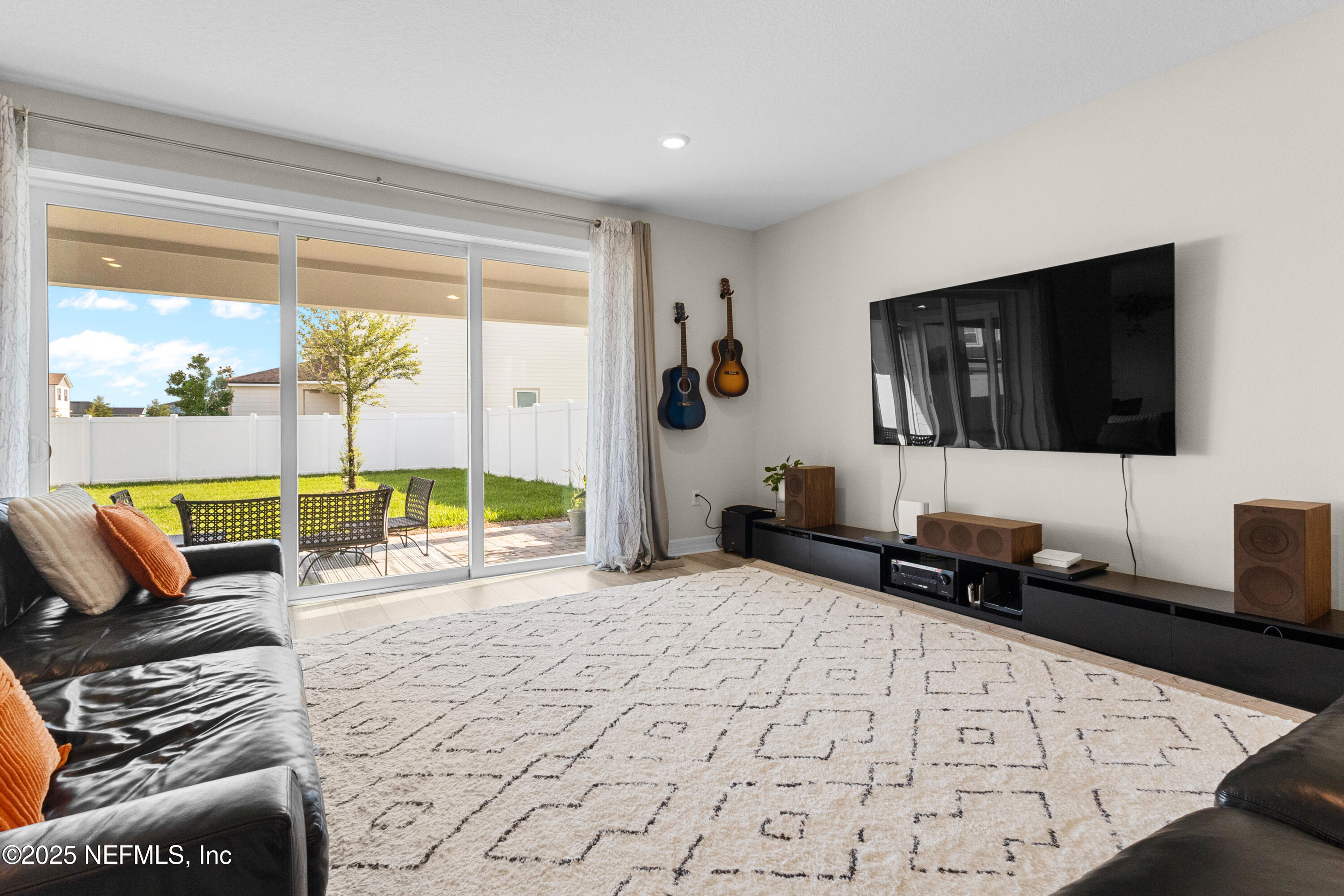 27 Flintlock Ln Street St. Augustine, FL 32095 - Photo 4 of 65 a living room with a couch a rug and a flat screen tv