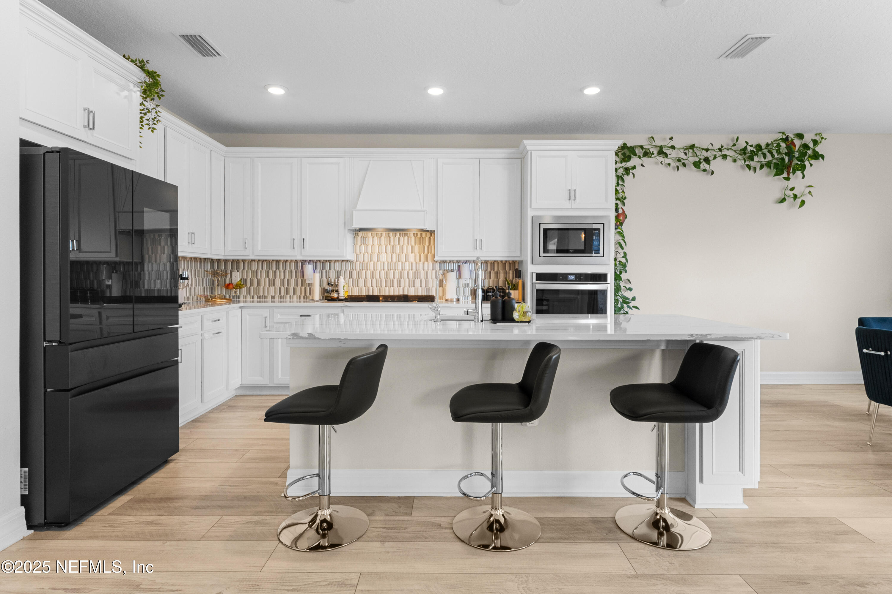 27 Flintlock Ln Street St. Augustine, FL 32095 - Photo 46 of 65 a kitchen with granite countertop a refrigerator oven a stove a dining table and chairs