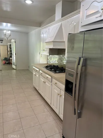 a kitchen with stainless steel appliances a sink stove and cabinets