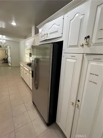 a kitchen with white cabinets and white appliances