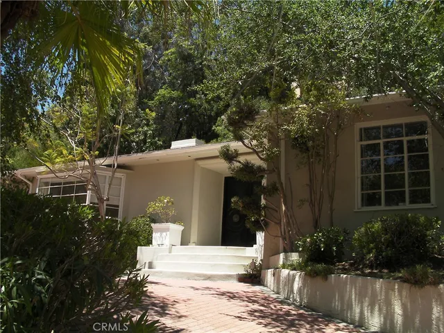 a view of a house with a yard garage and chair