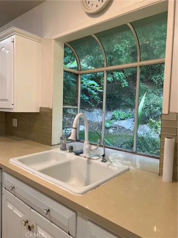 a kitchen with a sink and a large window