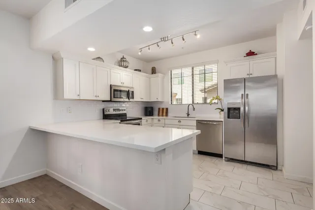 a kitchen with kitchen island a sink stove and refrigerator