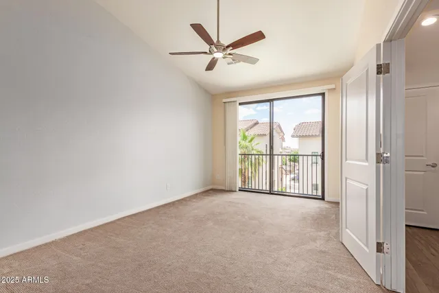 a view of a livingroom with a ceiling fan and window
