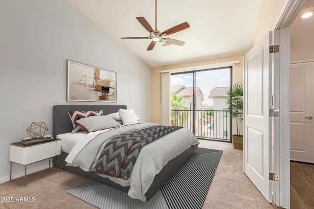 a bedroom with a balcony a bed and a large window