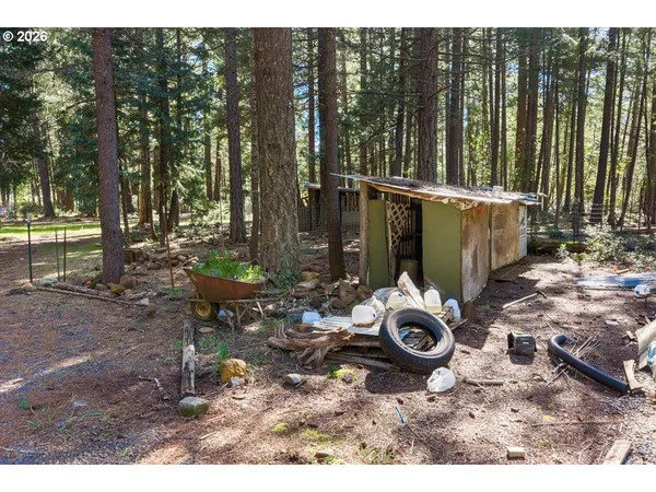 a backyard of a house with barbeque oven table and chairs