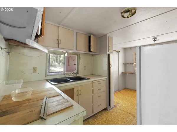 a kitchen with stainless steel appliances granite countertop a sink and a stove