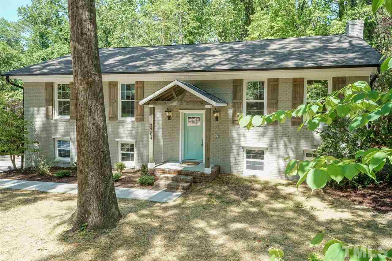 7204 Grist Mill Road Raleigh, NC 27615 - Photo 1 of 30 a front view of a house with a yard