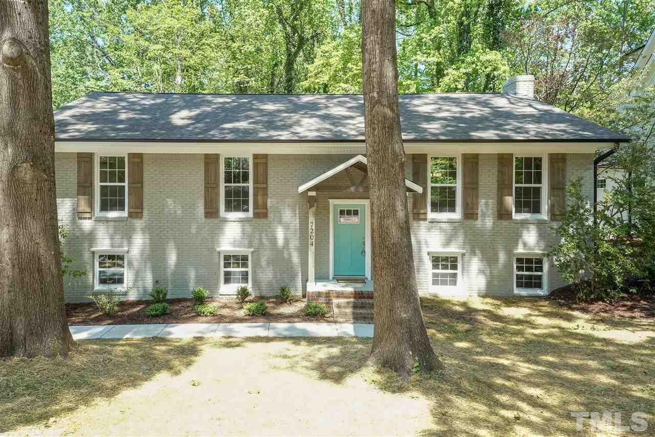 7204 Grist Mill Road Raleigh, NC 27615 - Photo 2 of 30 a front view of a house with a porch