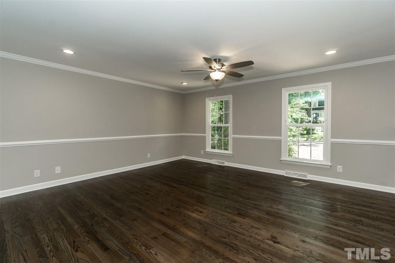 7204 Grist Mill Road Raleigh, NC 27615 - Photo 13 of 30 an empty room with wooden floor and windows