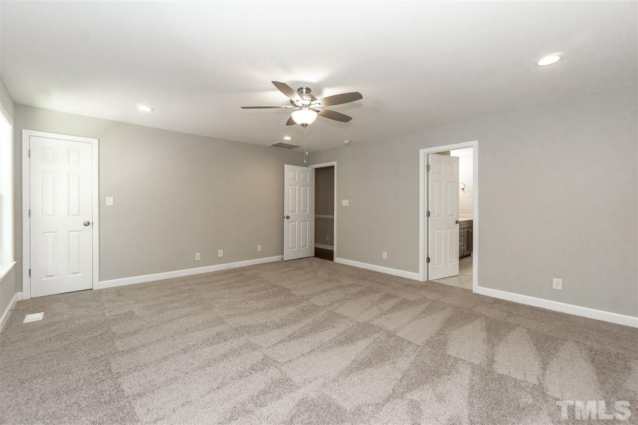 7204 Grist Mill Road Raleigh, NC 27615 - Photo 16 of 30 a view of an empty room with a ceiling fan