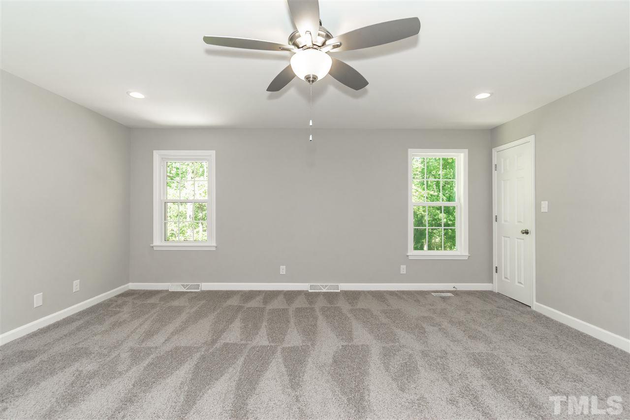 7204 Grist Mill Road Raleigh, NC 27615 - Photo 18 of 30 an empty room with windows and fan