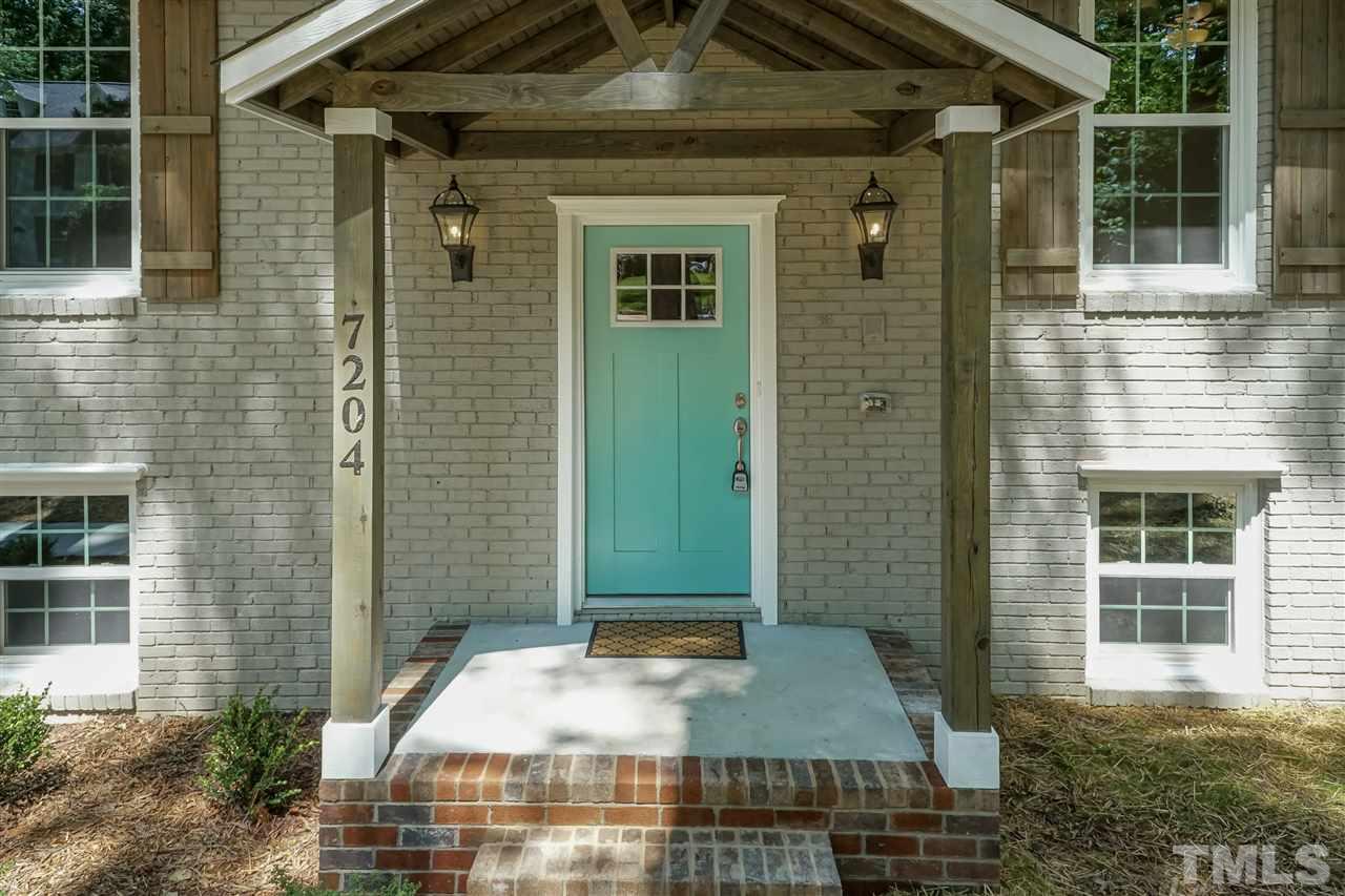 7204 Grist Mill Road Raleigh, NC 27615 - Photo 3 of 30 a front view of a house with a yard